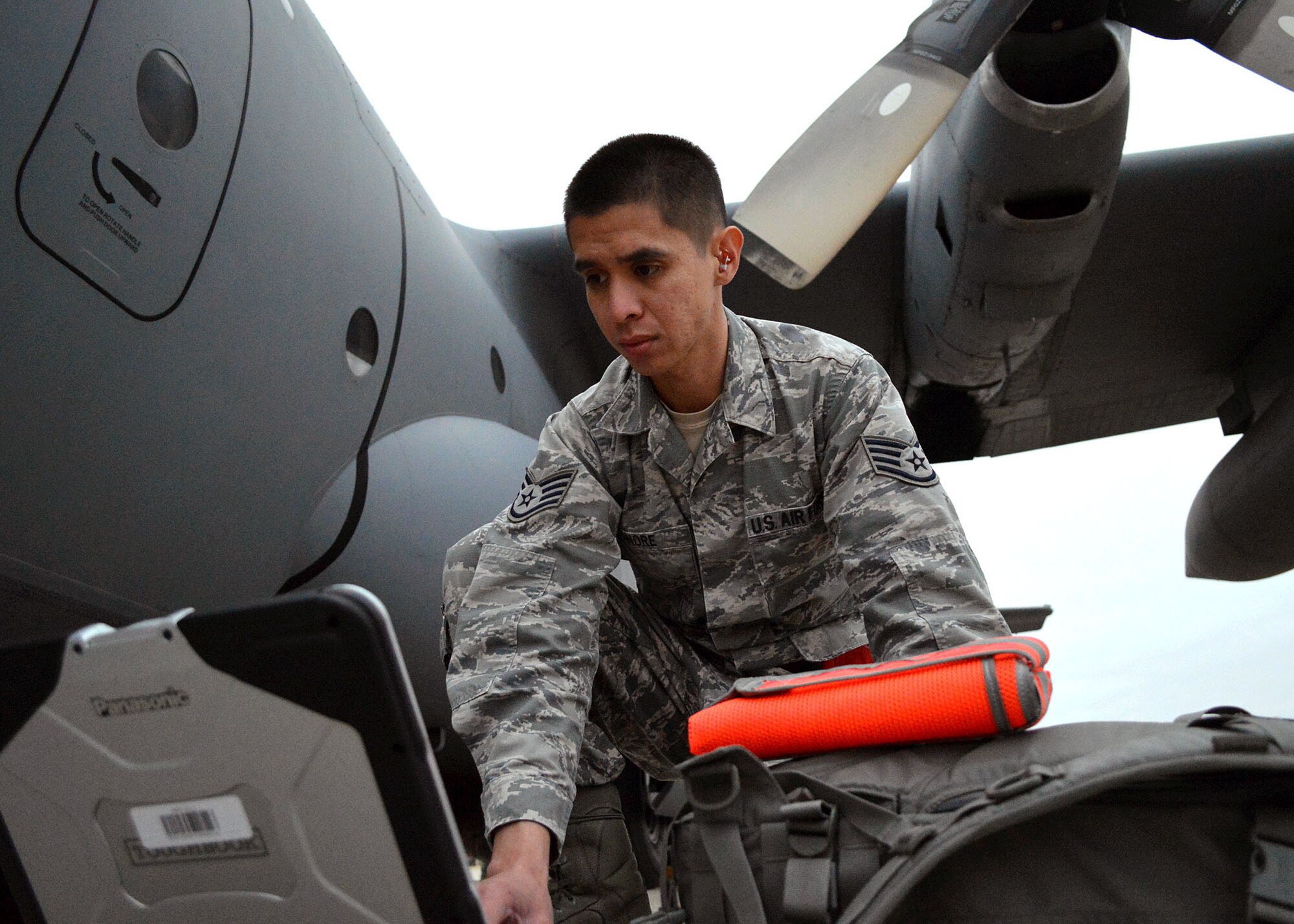 U.S. Air Force Staff Sgt. Julian Tanore, an aerospace propulsion journeyman assigned to the 43rd Aircraft Maintenance Squadron, reviews C-130H Hercules aircraft technical orders prior to airborne operations during the 17th Annual Randy Oler Memorial Operation Toy Drop on Dec. 6 at Green Ramp, Pope Army Airfield, Fort Bragg, North Carolina. Operation Toy Drop is the world’s largest combined airborne operation where Soldiers donate a toy to receive a lottery ticket number that are then randomly drawn for an opportunity to train and jump with foreign jumpmasters over Sicily Drop Zone. Foreign jumpmasters from Poland, Italy, Latvia, Germany, Indonesia and the Netherlands participated in this year’s event. Last year, Operation Toy Drop collected more than 12,000 toys that were donated to local charities and organizations across North Carolina. (U.S. Air Force photo/Marvin Krause)