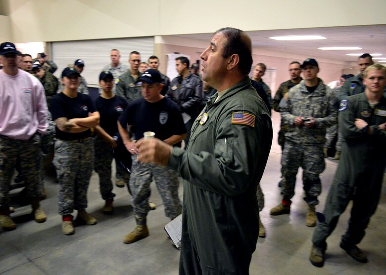 U.S. Air Force Reserve Master Sgt. Tony Flores, a loadmaster from the 95th Airlift Squadron, briefs U.S. Army and foreign jumpmasters prior to airborne operations during the 17th Annual Randy Oler Memorial Operation Toy Drop on Dec. 6 at Green Ramp, Pope Army Airfield, Fort Bragg, North Carolina. Operation Toy Drop is the world’s largest combined airborne operation where Soldiers donate a toy to receive a lottery ticket number that are then randomly drawn for an opportunity to train and jump with foreign jumpmasters over Sicily Drop Zone. Foreign jumpmasters from Poland, Italy, Latvia, Germany, Indonesia and the Netherlands participated in this year’s event. Last year, Operation Toy Drop collected more than 12,000 toys that were donated to local charities and organizations across North Carolina. (U.S. Air Force photo/Marvin Krause)