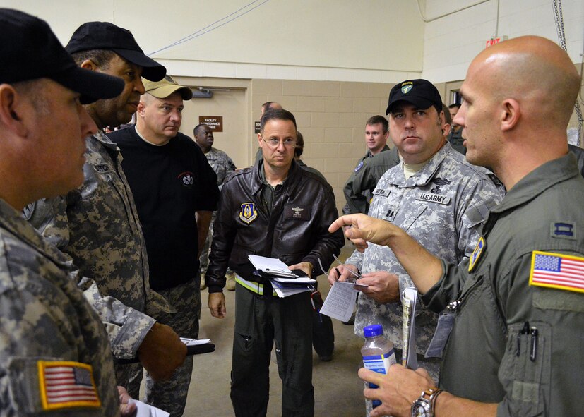 U.S. Air Force Capt. Steven Bergstrom, right, Air Force mission commander for Operation Toy Drop from the 2nd Airlift Squadron, briefs U.S. Army jumpmasters and Air Force Reserve Lt. Col. Paul Pepe Jr., a C-130H Hercules aircraft pilot from the 95th Airlift Squadron, prior to airborne operations during the 17th Annual Randy Oler Memorial Operation Toy Drop on Dec. 6 at Green Ramp, Pope Army Airfield, Fort Bragg, North Carolina. Operation Toy Drop is the world’s largest combined airborne operation where Soldiers donate a toy to receive a lottery ticket number that are then randomly drawn for an opportunity to train and jump with foreign jumpmasters over Sicily Drop Zone. Foreign jumpmasters from Poland, Italy, Latvia, Germany, Indonesia and the Netherlands participated in this year’s event. Last year, Operation Toy Drop collected more than 12,000 toys that were donated to local charities and organizations across North Carolina. (U.S. Air Force photo/Marvin Krause)