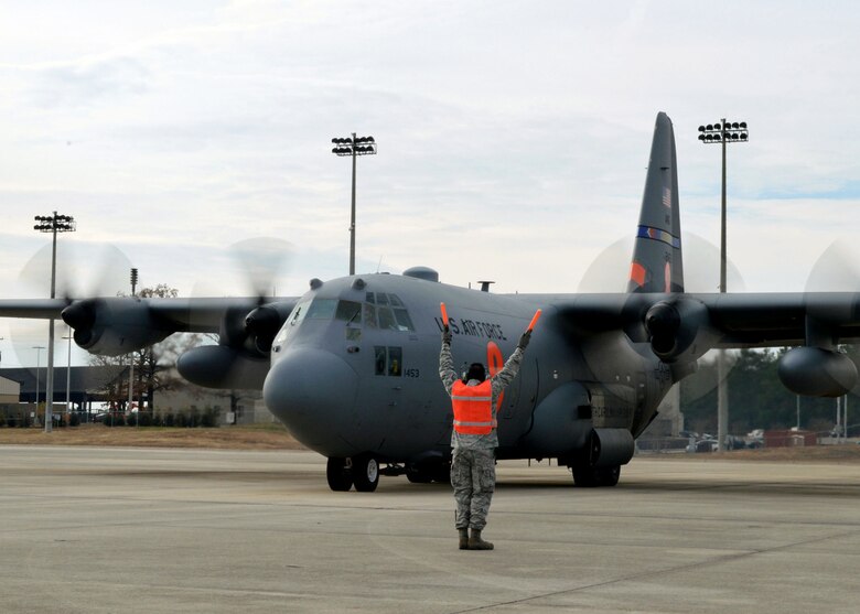 U.S. Air Force Staff Sgt. Brandon Thomas, 43rd Aircraft Maintenance Squadron, marshals a North Carolina Air National Guard C-130 Hercules aircraft from the 145th Airlift Wing, Charlotte, North Carolina, during 17th Annual Randy Oler Memorial Operation Toy Drop on Dec. 5 at Green Ramp, Pope Army Airfield, Fort Bragg, North Carolina. Operation Toy Drop is the world’s largest combined airborne operation where Soldiers donate a toy to receive a lottery ticket number that are then randomly drawn for an opportunity to train and jump with foreign jumpmasters over Sicily Drop Zone. Foreign jumpmasters from Poland, Italy, Latvia, Germany, Indonesia and the Netherlands participated in this year’s event. Last year, Operation Toy Drop collected more than 12,000 toys that were donated to local charities and organizations across North Carolina. (U.S. Air Force photo/Marvin Krause)


