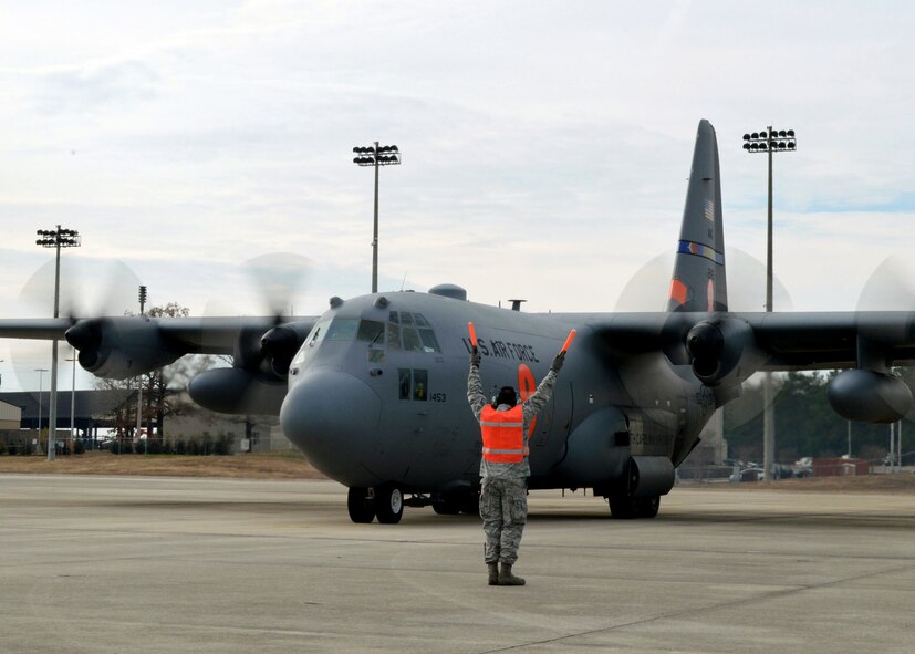 U.S. Air Force Staff Sgt. Brandon Thomas, 43rd Aircraft Maintenance Squadron, marshals a North Carolina Air National Guard C-130 Hercules aircraft from the 145th Airlift Wing, Charlotte, North Carolina, during 17th Annual Randy Oler Memorial Operation Toy Drop on Dec. 5 at Green Ramp, Pope Army Airfield, Fort Bragg, North Carolina. Operation Toy Drop is the world’s largest combined airborne operation where Soldiers donate a toy to receive a lottery ticket number that are then randomly drawn for an opportunity to train and jump with foreign jumpmasters over Sicily Drop Zone. Foreign jumpmasters from Poland, Italy, Latvia, Germany, Indonesia and the Netherlands participated in this year’s event. Last year, Operation Toy Drop collected more than 12,000 toys that were donated to local charities and organizations across North Carolina. (U.S. Air Force photo/Marvin Krause)

