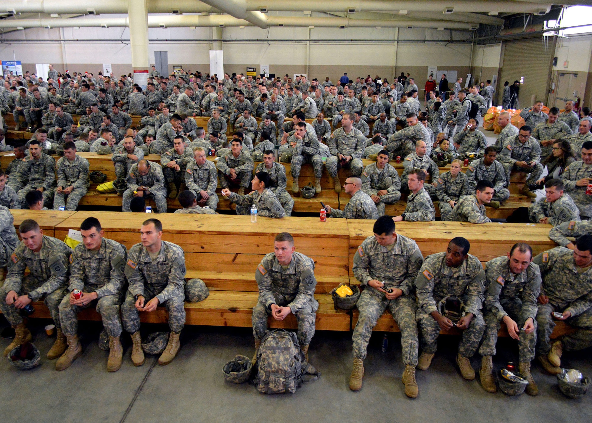 Fort Bragg paratroopers wait to see if their lottery number is called during the 17th Annual Randy Oler Memorial Operation Toy Drop, at Green Ramp, Pope Army Airfield, Fort Bragg, North Carolina on Dec. 5. Operation Toy Drop is the world’s largest combined airborne operation where Soldiers donate a toy to receive a lottery ticket number that are then randomly drawn for an opportunity to train and jump with foreign jumpmasters over Sicily Drop Zone. Foreign jumpmasters from Poland, Italy, Latvia, Germany, Indonesia and the Netherlands participated in this year’s event. Last year, Operation Toy Drop collected more than 12,000 toys that were donated to local charities and organizations across North Carolina. (U.S. Air Force photo/Marvin Krause)