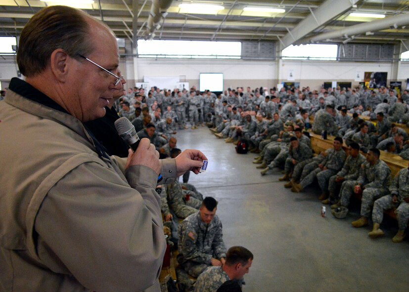 Don Chase, 95.7 WKNL radio personality, Fayetteville, North Carolina, announces lottery ticket numbers during the 17th Annual Randy Oler Memorial Operation Toy Drop, at Green Ramp, Pope Army Airfield, Fort Bragg, North Carolina on Dec. 5. Operation Toy Drop is the world’s largest combined airborne operation where Soldiers donate a toy to receive a lottery ticket number that are then randomly drawn for an opportunity to train and jump with foreign jumpmasters over Sicily Drop Zone. Foreign jumpmasters from Poland, Italy, Latvia, Germany, Indonesia and the Netherlands participated in this year’s event. Last year, Operation Toy Drop collected more than 12,000 toys that were donated to local charities and organizations across North Carolina. (U.S. Air Force photo/Marvin Krause)