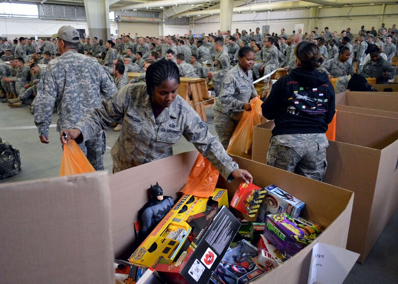 U.S. Air Force Staff Sgt. Eneida Roper-Cary, left, and Staff Sgt. Britiane Graham, both assigned to the 43rd Force Support Squadron, along with other Airmen, sort toys during the 17th Annual Randy Oler Memorial Operation Toy Drop, at Green Ramp, Pope Army Airfield, Fort Bragg, North Carolina on Dec. 5. Operation Toy Drop is an annual U.S. Army Civil Affairs and Psychological Operations Command (Airborne) sponsored event. Toy Drop gathers thousands of toys donated by Fort Bragg Soldiers and Pope Airmen and distributes them to local area children who might otherwise not receive a toy during the holidays. A large airborne operation is also part of Toy Drop. Paratroopers will get a chance to train and jump with a jumpmaster from one of six countries participating this year. This allows them to earn foreign airborne or “jump” wings. (U.S. Air Force photo/Marvin Krause)