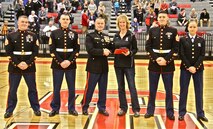 Major Christopher Buck, Commanding Officer of Recruiting Station Lansing, 9th Marine Corps District, presents Sarah Bulthuis, retired Spring Lake varsity volleyball head coach, with the 2013-2014 Recruiting Station Lansing Semper Fidelis Michigan High School Coach of the Year Award. RS Lansing selects one male and one female coach with this award each year for their contributions to their teams, communities and students. Bulthuis retired after 27 years of coaching at Spring Lake, finishing her career with 44 wins in her final season. 