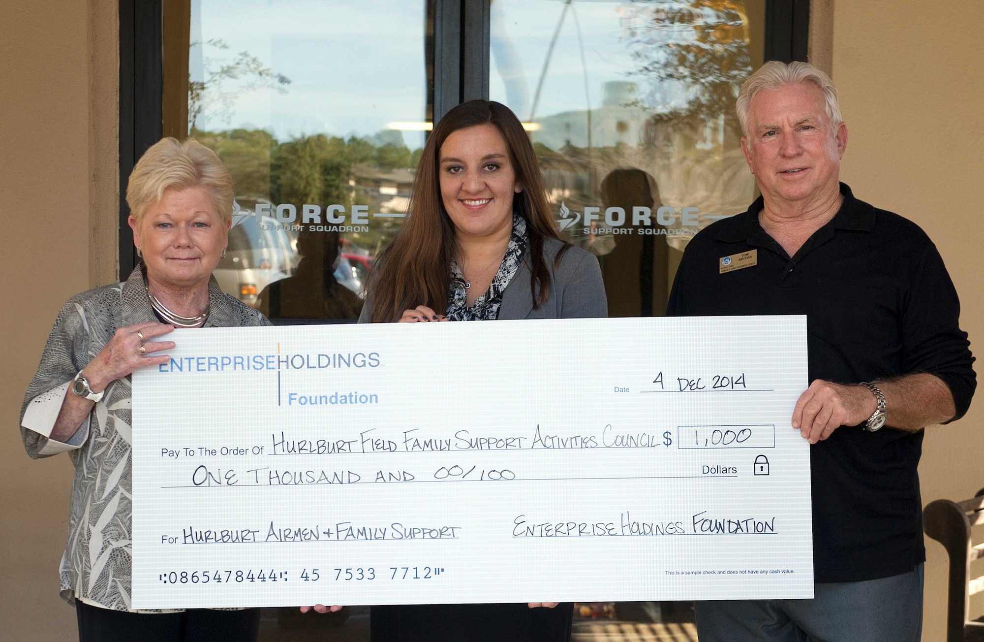 The Airman & Family Readiness Center received a $1,000 donation to support the Hurlburt Family Support Activities Council, Dec. 4, 2014 on Hurlburt Field, Fla. The council is a nonprofit program which assists Air Commandos and their families with financial aid and support by rendering temporary childcare, support movie nights for kids and even the offer an occasional monetary grant to Airmen in need. (U.S. Air Force photo/ Staff Sgt. Kentavist P. Brackin)