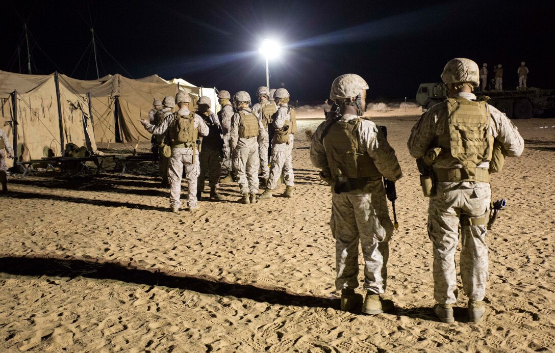 Marines with Marine Wing Support Squadron 371 prepare for a perimeter sweep foot patrol during the security force exercise in support of pre-deployment training Dec. 7-10, 2014, at the Auxiliary Landing Field II on Marine Corps Air Station Yuma, Ariz. The exercise provided Marines a hands-on experience for installation night and day security operations. (U.S. Marine Corps photo by Cpl. Reba James/ Released)