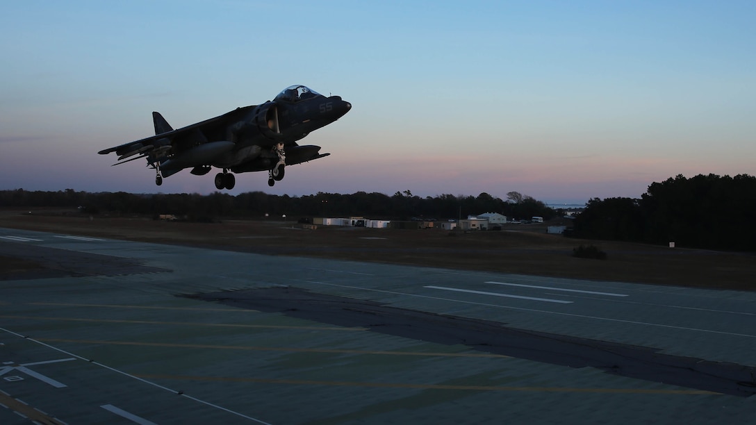 An AV-8B Harrier hovers during field carrier landing practice sustainment training at Marine Corps Auxiliary Landing Field Bogue, N.C., Dec. 5, 2014. Marines with Marine Attack Squadron 231 honed their skills in preparation for an upcoming deployment with the 24th Marine Expeditionary Unit.