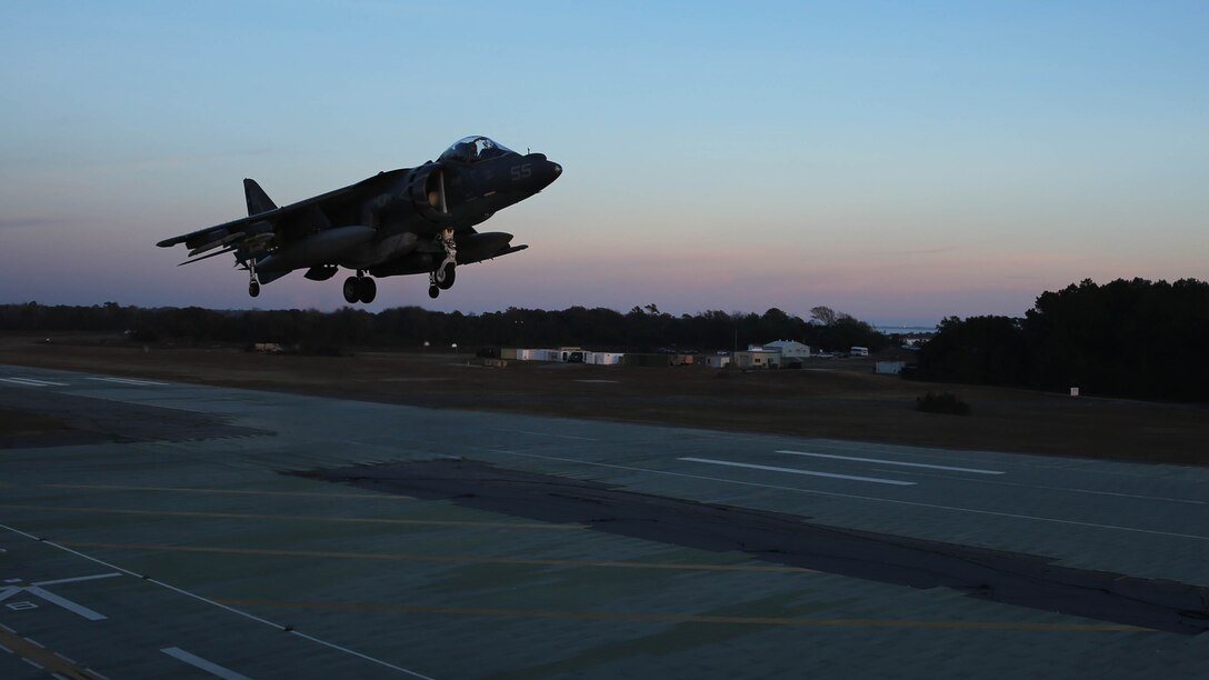 An AV-8B Harrier hovers during field carrier landing practice sustainment training at Marine Corps Auxiliary Landing Field Bogue, N.C., Dec. 5, 2014. Marines with Marine Attack Squadron 231 honed their skills in preparation for an upcoming deployment with the 24th Marine Expeditionary Unit.