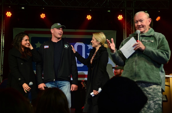 Army Gen. Martin E. Dempsey, right, chairman of the Joint Chiefs of Staff, speaks during the USO’s holiday show at Royal Air Force Mildenhall, England, Dec. 10, 2014.