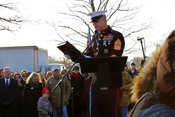 Marine Corps Sgt. Maj. Bryan Battaglia, senior enlisted advisor to the Chairman of the Joint Chiefs of Staff, addresses service members and volunteers during the opening ceremony on Wreaths Across America Day in Arlington National Cemetery, Arlington, Va., Dec. 13, 2014. Battaglia read a letter co-written with Army Gen. Martin E. Dempsey, chairman of the Joint Chiefs of Staff, thanking Wreaths Across America cofounders Morill and Karen Worcester for their support of fallen service members.