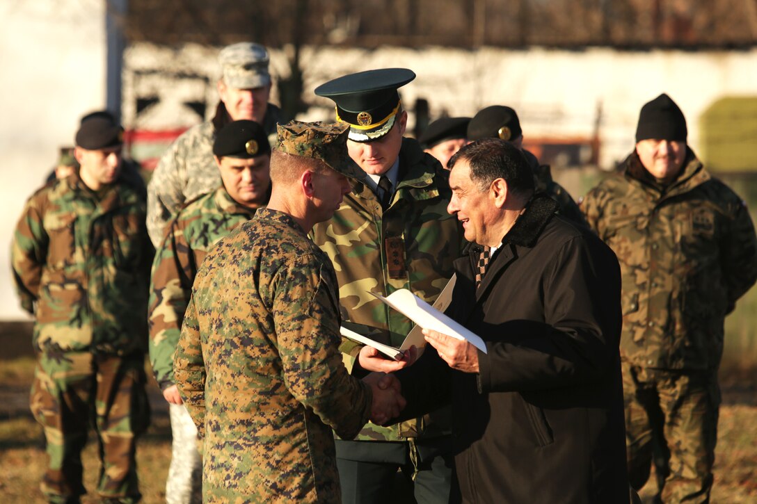 Minister of Defense Valerin Troenco shakes hands with Lt. Col. Joel Schmidt, the commanding officer of Black Sea Rotational Force 14, during the closing ceremony of the Anti-Armor Workshop between U.S. Marines and Moldovan soldiers in Balti, Moldova, Dec. 12. The Marines and Moldovans built a mutual understanding of firing procedures and characteristics on advanced anti-armor weapons systems, including: Moldova’s Rocket Propelled Grenade system and 70mm Recoiless Rifle (SPG), and America’s FGM-148 Javelin man-portable anti-tank missile, AT-4 Anti-Tank Weapon, and the Shoulder-launched Multipupose Assault Weapon, Dec. 8-12. 