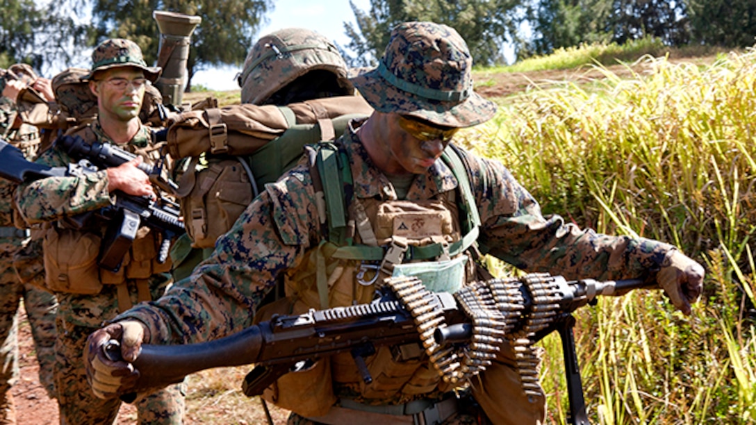 U.S. Marines attending Infantry Squad Leaders Course (ISLC), School of Infantry, West, are hiking to establish a defensive position on the  Army's Kahuku Training Area, Hawaii, Aug. 30, 2011.The mission of ISLC is to train infantrymen to be able to take charge of Marines in a combat environment. (U.S. Marine Corps photo by Lance Cpl. Demetrius Munnerlyn/Released) 