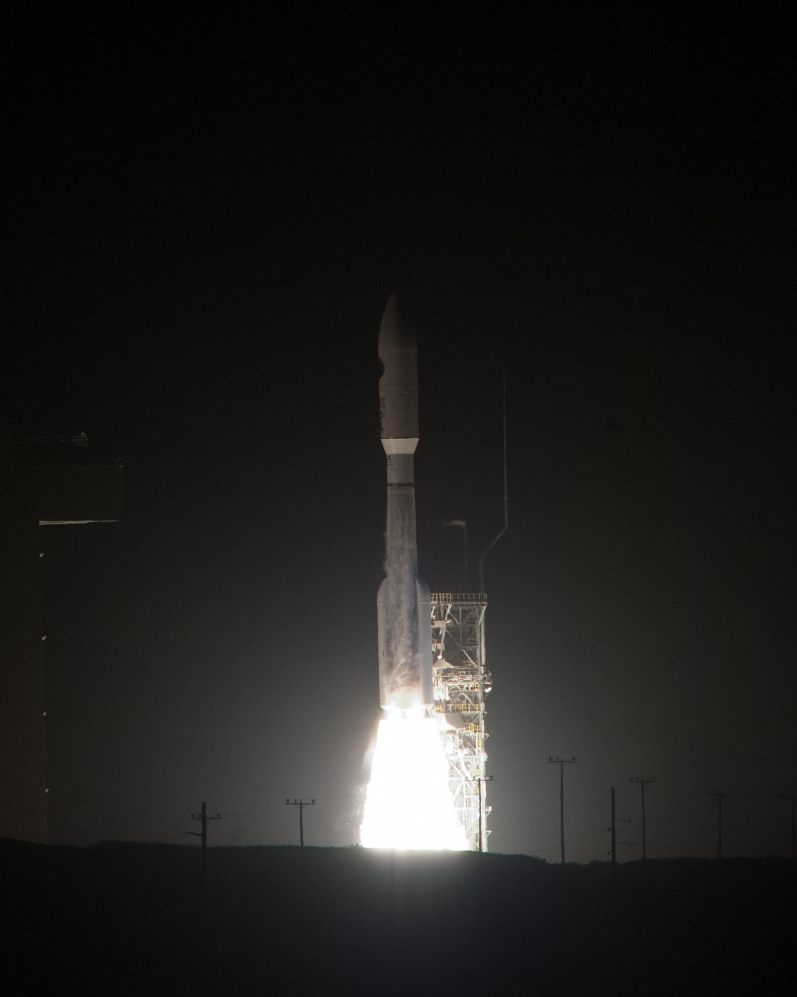 A United Launch Alliance Atlas V rocket carrying a National Reconnaissance Office payload successfully launches Dec. 12, 2014, from Space Launch Complex-3 at Vandenberg Air Force Base, Calif. This was the most powerful Atlas V rocket launched from Vandenberg because it had four solid rocket boosters, producing approximately 250,000 pounds of thrust per solid rocket. The four solids along with the main engine of the Atlas V produced a total thrust around 2 million pounds at liftoff. (U.S. Air Force photo/Michael Peterson)