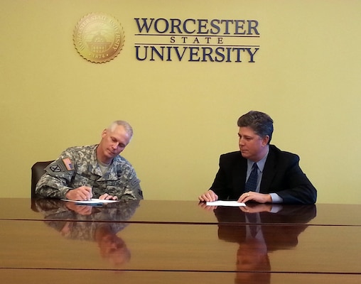 Col. Christopher Barron, New England District Commander, signs a STEM partnership agreement with Worcester State University's president, Barry Maloney, Oct. 27, 2014.