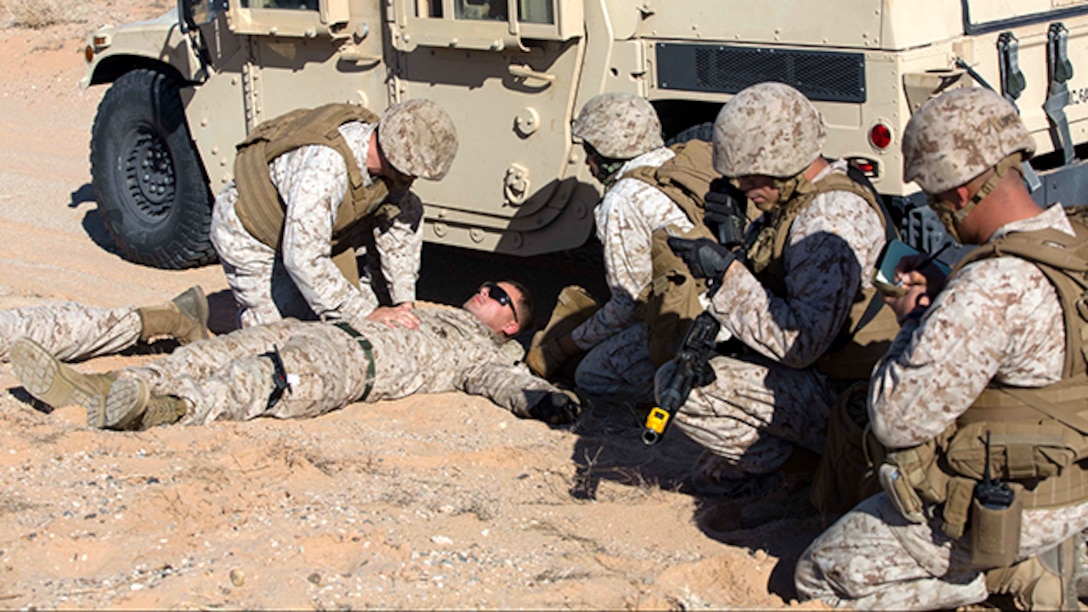 Marines with Marine Wing Support Squadron 371 perform casualty care while on patrol during the security force exercise in support of pre-deployment training Dec. 7-10, 2014, at the Auxiliary Landing Field II on Marine Corps Air Station Yuma, Ariz. As a part of the exercise, Marines called in a 9-line casualty evacuation as if they were deployed, in order to get the casualty to safety. (U.S. Marine Corps photo by Cpl. Reba James/ Released)