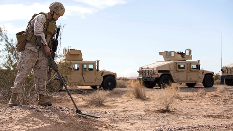 An Explosive Ordnance Marine with Marine Wing Support Squadron 371 sweeps for improvised explosive devices during the security force exercise in support of pre-deployment training Dec. 7-10, 2014, at the Auxiliary Landing Field II on Marine Corps Air Station Yuma, Ariz. The exercise allowed senior leaders to instruct and advise Marines on security operations, such as calling in the EOD team when there is a suspected IED. (U.S. Marine Corps photo by Cpl. Reba James/ Released)