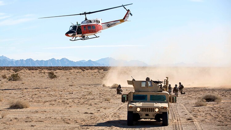 A Marine search and rescue team with Marine Corps Air Station Yuma, Ariz., departs the landing zone after a casualty evacuation in support of Marine Wing Support Squadron 371 during the security force exercise in support of pre-deployment training Dec. 7-10, 2014, at Auxiliary Landing Field II on station. (U.S. Marine Corps photo by Cpl. Reba James/ Released)