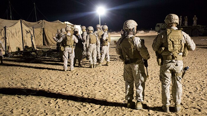 Marines with Marine Wing Support Squadron 371 prepare for a perimeter sweep foot patrol during the security force exercise in support of pre-deployment training Dec. 7-10, 2014, at the Auxiliary Landing Field II on Marine Corps Air Station Yuma, Ariz. The exercise provided Marines a hands-on experience for installation night and day security operations. (U.S. Marine Corps photo by Cpl. Reba James/ Released)