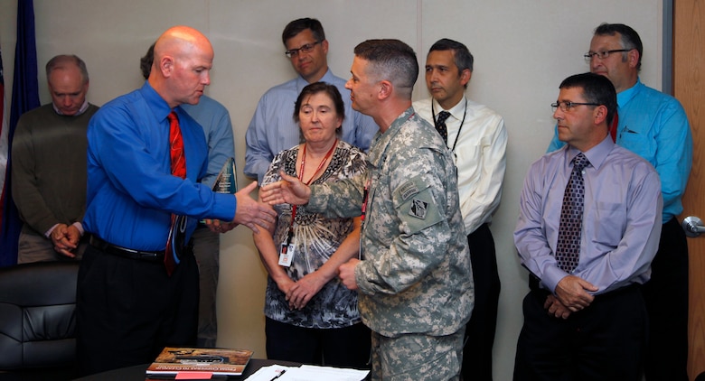 Lt. Col. Charles Gray, Deputy Commander, New England District, presents Stephen Dunbar and other members of the Elizabeth Mine Superfund Site Project Delivery Team (PDT) the prestigious Green Dream Team Award in the 2014 USACE Sustainability Award Program during a virtual awards ceremony held via video teleconference (VTC) on Oct. 7, 2014.
