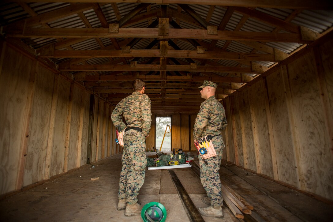 U.S. Marine Cpl. Michael Beck, left, and Sgt. Richard Contrady perform a quality check on a Southwest Asia hut during realistic urban training aboard Fort Hunter Liggett, Calif., Dec. 14, 2014. Beck and Contrady are combat engineers with Combat Logistics Battalion 15, 15th Marine Expeditionary Unit. RUT prepares the 15th MEU's Marines for their upcoming deployment, enhancing their combat skills in environments similar to those they may find in future missions. (U.S. Marine Corps photo by Sgt. Jamean Berry/Released)