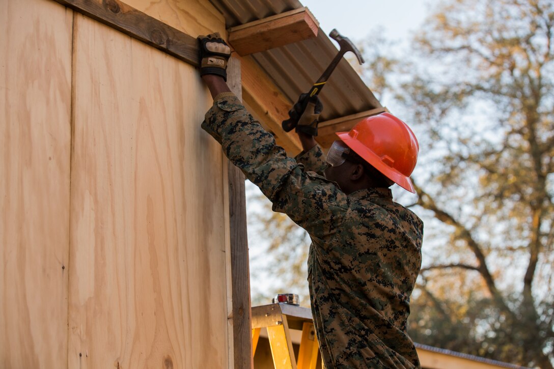 U.S. Marine Cpl. Shaquille Ross installs components of a Southwest Asia hut during realistic urban training aboard Fort Hunter Liggett, Calif., Dec. 14, 2014. Ross is a combat engineer with Combat Logistics Battalion 15, 15th Marine Expeditionary Unit. RUT prepares the 15th MEU's Marines for their upcoming deployment, enhancing their combat skills in environments similar to those they may find in future missions. (U.S. Marine Corps photo by Sgt. Jamean Berry/Released)