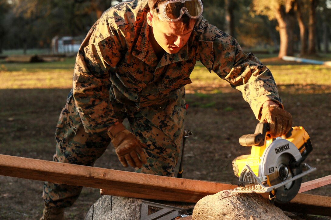 U.S. Marine Cpl. Daven Burney cuts beams to be used in a Southwest Asia hut during realistic urban training aboard Fort Hunter Liggett, Calif., Dec. 14, 2014. Burney is a combat engineer with Combat Logistics Battalion 15, 15th Marine Expeditionary Unit. RUT prepares the 15th MEU's Marines for their upcoming deployment, enhancing their combat skills in environments similar to those they may find in future missions. (U.S. Marine Corps photo by Sgt. Jamean Berry/Released)