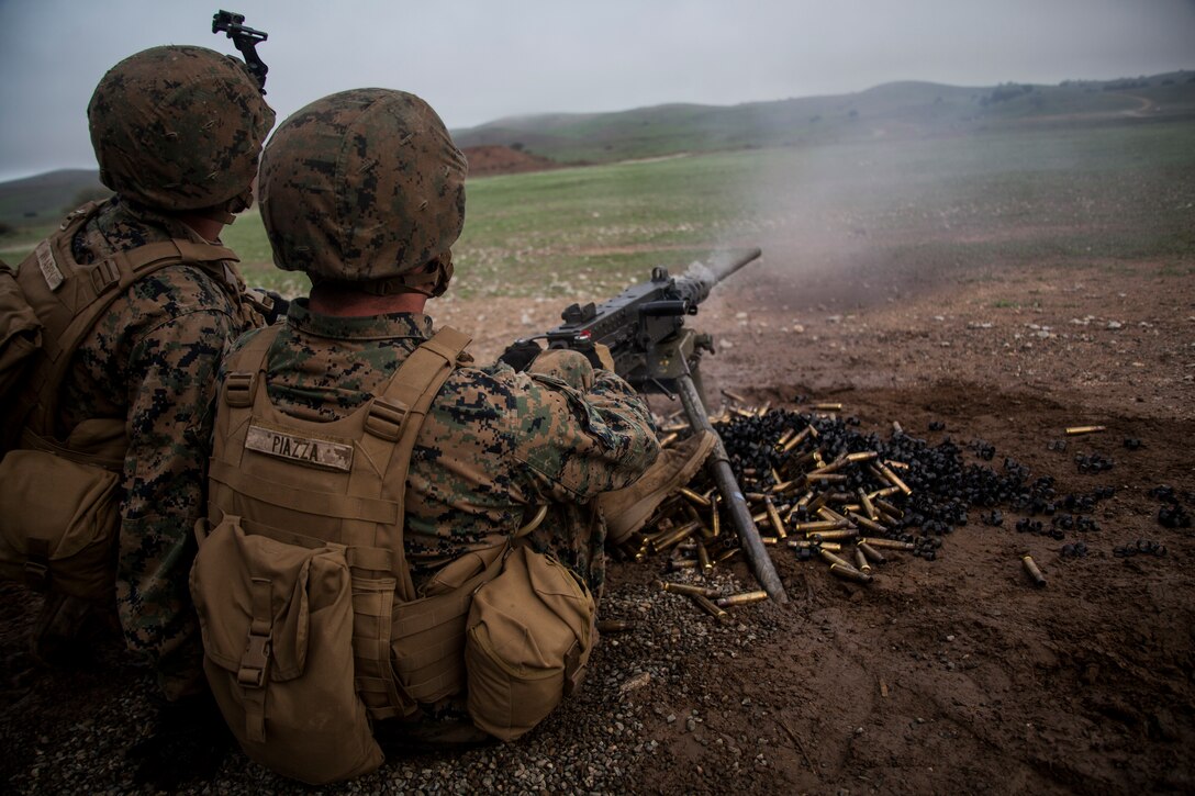 U.S. Marine Pfc. Jacob Piazza, right, fires a .50-caliber machine gun at targets during realistic urban training aboard Camp Roberts, Calif., Dec. 14, 2014. Piazza is a rifleman with Weapons Company, Battalion Landing Team 3rd Battalion, 1st Marine Regiment, 15th Marine Expeditionary Unit. RUT prepares the 15th MEU’s Marines for their upcoming deployment, enhancing their combat skills in environments similar to those they may find in future missions. (U.S. Marine Corps photo by Cpl. Elize McKelvey/Released)