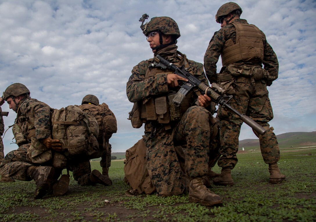 U.S. Marine Lance Cpl. Mark Jerry, middle, covers fellow Marines during realistic urban training aboard Camp Roberts, Calif., Dec. 14, 2014. Jerry is a scout sniper with Weapons Company, Battalion Landing Team 3rd Battalion, 1st Marine Regiment, 15th Marine Expeditionary Unit. RUT prepares the 15th MEU’s Marines for their upcoming deployment, enhancing their combat skills in environments similar to those they may find in future missions. (U.S. Marine Corps photo by Cpl. Elize McKelvey/Released)