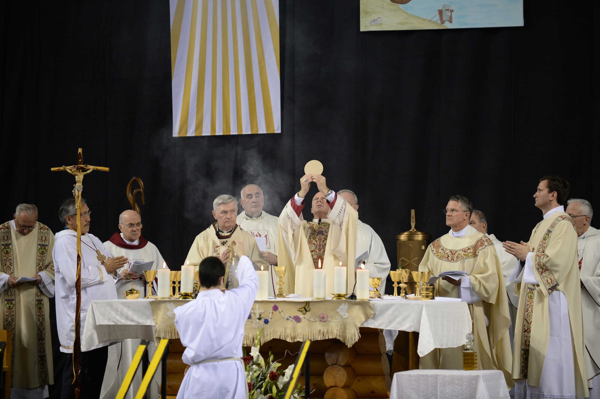 Chaplain (Maj.) Chad Zielinski, the 354th Fighter Wing deputy wing chaplain, give his first communion after being ordained the bishop of the Fairbanks Catholic diocese Dec. 15, 2014 at the Carlson Center, Fairbanks, Alaska. Zielinski’s will be responsible for overseeing Catholic interests in an area the size of Texas, much of which isn’t accessible by road. (U.S. Air Force photo by Staff Sgt. Shawn Nickel/Released) 