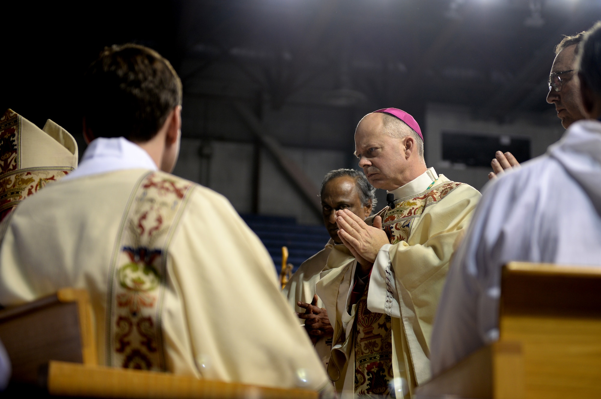 Chaplain (Maj.) Chad Zielinski, the 354th Fighter Wing deputy wing chaplain, prays during a ceremony ordaining him the bishop of the Fairbanks Catholic diocese Dec. 15, 2014 at the Carlson Center, Fairbanks, Alaska. Zielinski’s will be responsible for overseeing Catholic interests in an area the size of Texas, much of which isn’t accessible by road. (U.S. Air Force photo by Staff Sgt. Shawn Nickel/Released)