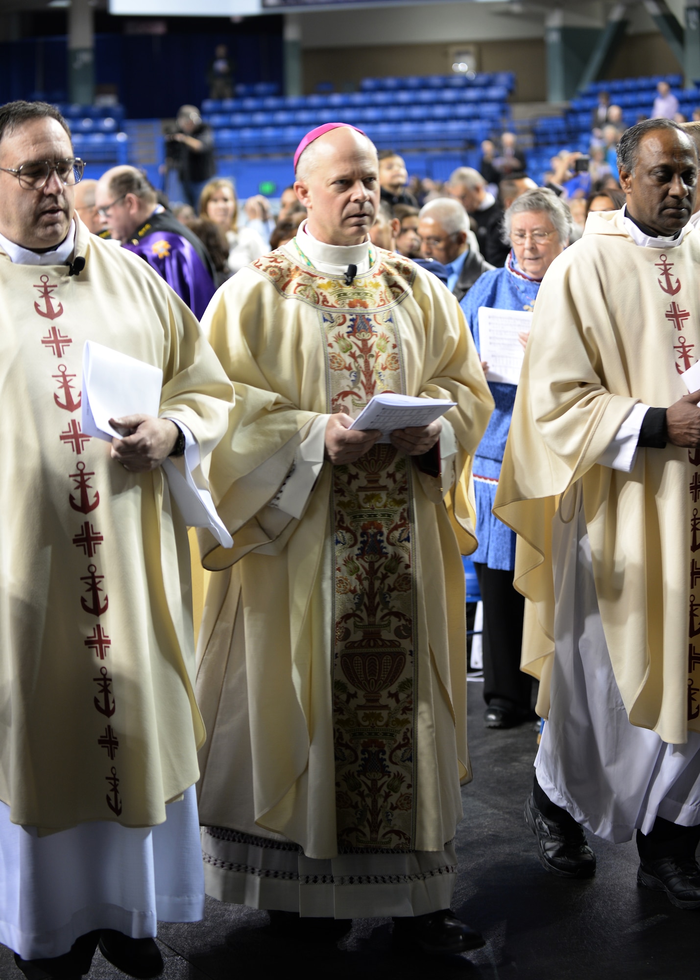 Chaplain (Maj.) Chad Zielinski, the 354th Fighter Wing deputy wing chaplain, walks to the stage during a ceremony ordaining him the bishop of the Fairbanks Catholic diocese Dec. 15, 2014 at the Carlson Center, Fairbanks, Alaska. This is the first time an active-duty Airman has been chosen for a position of this magnitude. (U.S. Air Force photo by Staff Sgt. Shawn Nickel/Released)