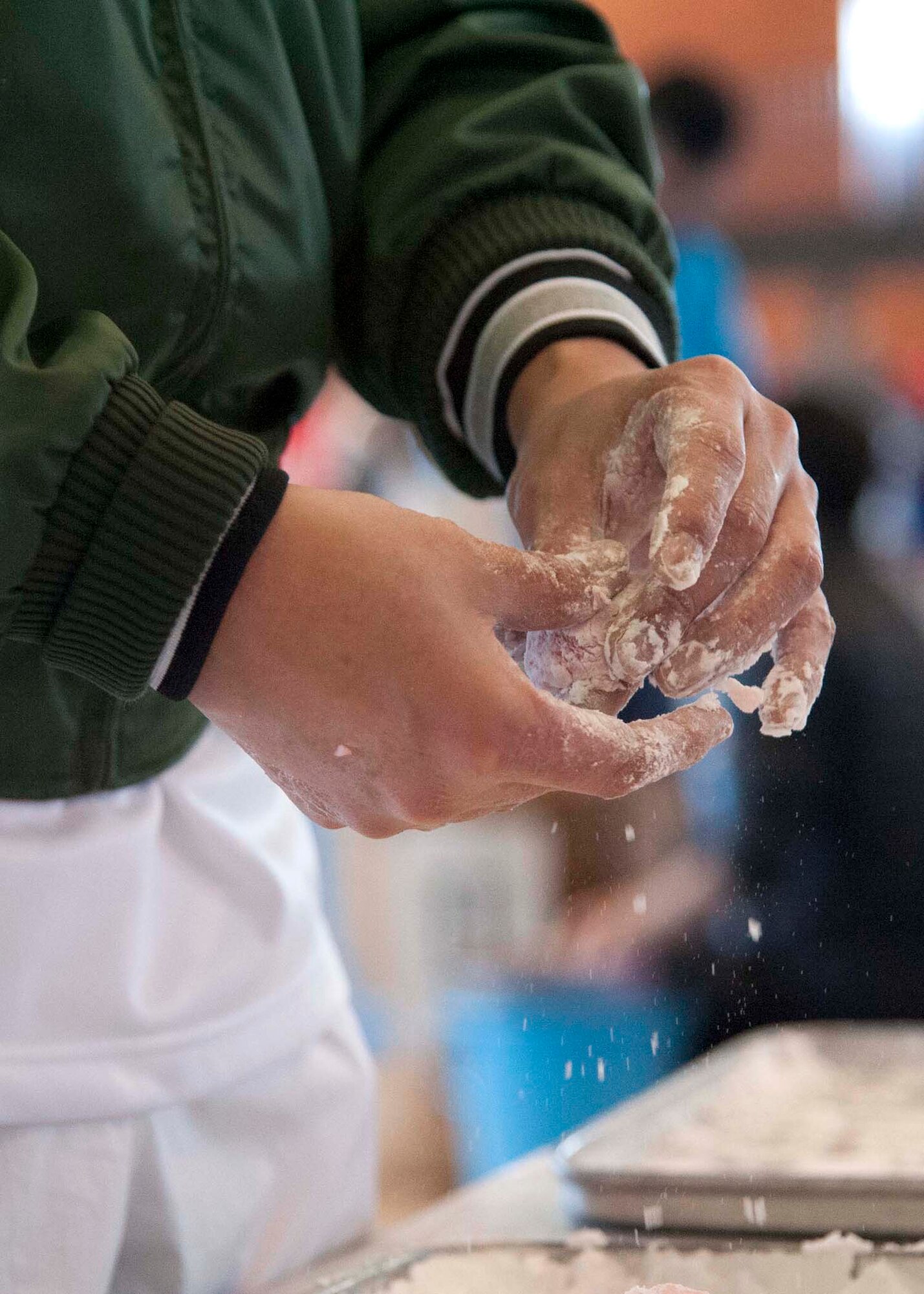A Japan Air-Self Defense Force volunteer shapes a rice cake during the annual Mochi Pounding Ceremony at the Japan Air-Self Defense Force facility at Misawa Air Base, Japan, Dec. 15, 2014. Members of the 35th Fighter Wing, Naval Air Facility, Japan Air Self-Defense Force and local community experienced this first hand when they gathered to share in the Japanese tradition of making mochi. (U.S. Air Force photo by Staff Sgt. Tong Duong/Released.)

