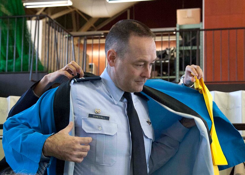 U.S. Air Force Col. Timothy Sundvall, 35th Fighter Wing commander, dons a Happi Coat prior to the start of the annual Mochi Pounding Ceremony at a Japan Air-Self Defense Force facility at Misawa Air Base, Japan, Dec. 15, 2014. The Happi Coat helps to protect clothing from bits of steamed glutinous rice as it is pounded into mochi. (U.S. Air Force photo by Staff Sgt. Tong Duong/Released) 


