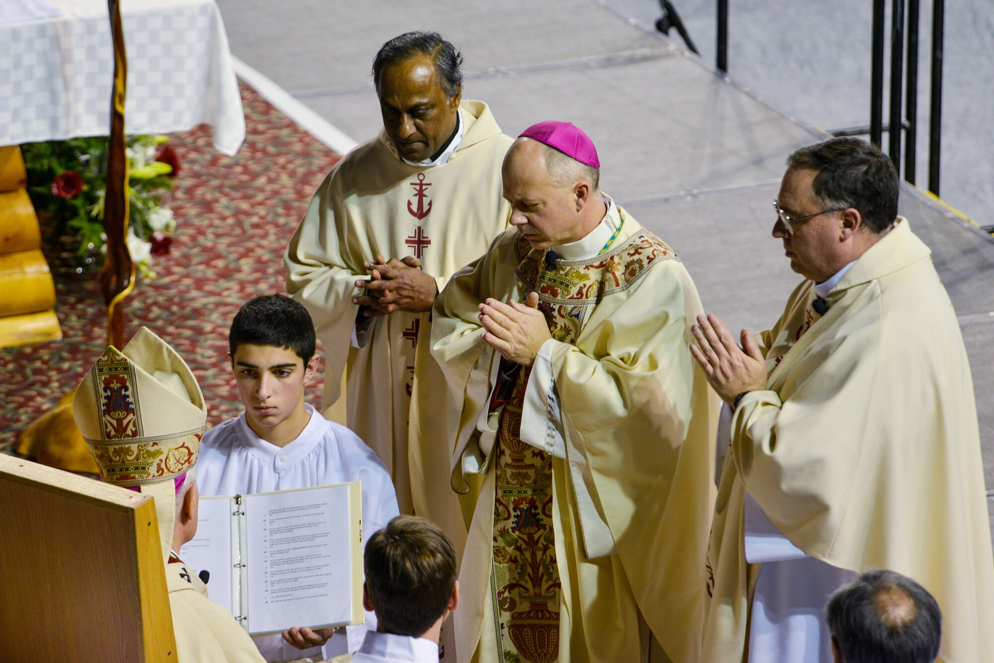 Rev. Roger L. Schwietz, Archbishop of Anchorage, Alaska, prays with Chaplain (Maj.) Chad Zielinski, the 354th Fighter Wing deputy wing chaplain, before ordaining Zielinski the bishop of the Fairbanks Catholic diocese Dec. 15, 2014, at the Carlson Center, Fairbanks, Alaska. Zielinski will be responsible for overseeing Catholic interests in an area the size of Texas, much of which isn't accessible by road. (U.S. Air Force photo by Tech. Sgt. Joseph Swafford/Released)