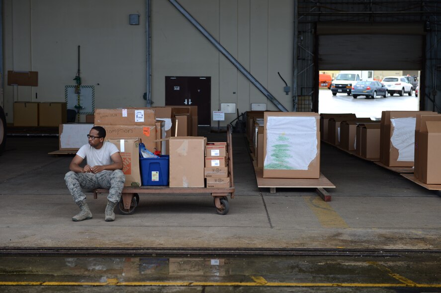 Senior Airman Demar Russell, Supply Technician, 374th Aircraft Maintenance Group, 374th Airlift Wing, Yokota Air Base, Japan, observes flight line operations during Operation Christmas Drop 2014. OCD, a partnership between the 374th Airlift Wing, the 36th Wing at Andersen Air Force Base, Guam and the 515th Air Mobility Operations Wing, Joint Base Pearl Harbor-Hickam, HI, is the longest-running Department of Defense-led humanitarian airlift operation and will provide 25 tons of critical supplies to 56 islands this year. (U.S. Air Force photo by Capt. Mark Lazane/374th Airlift Wing Public Affairs)