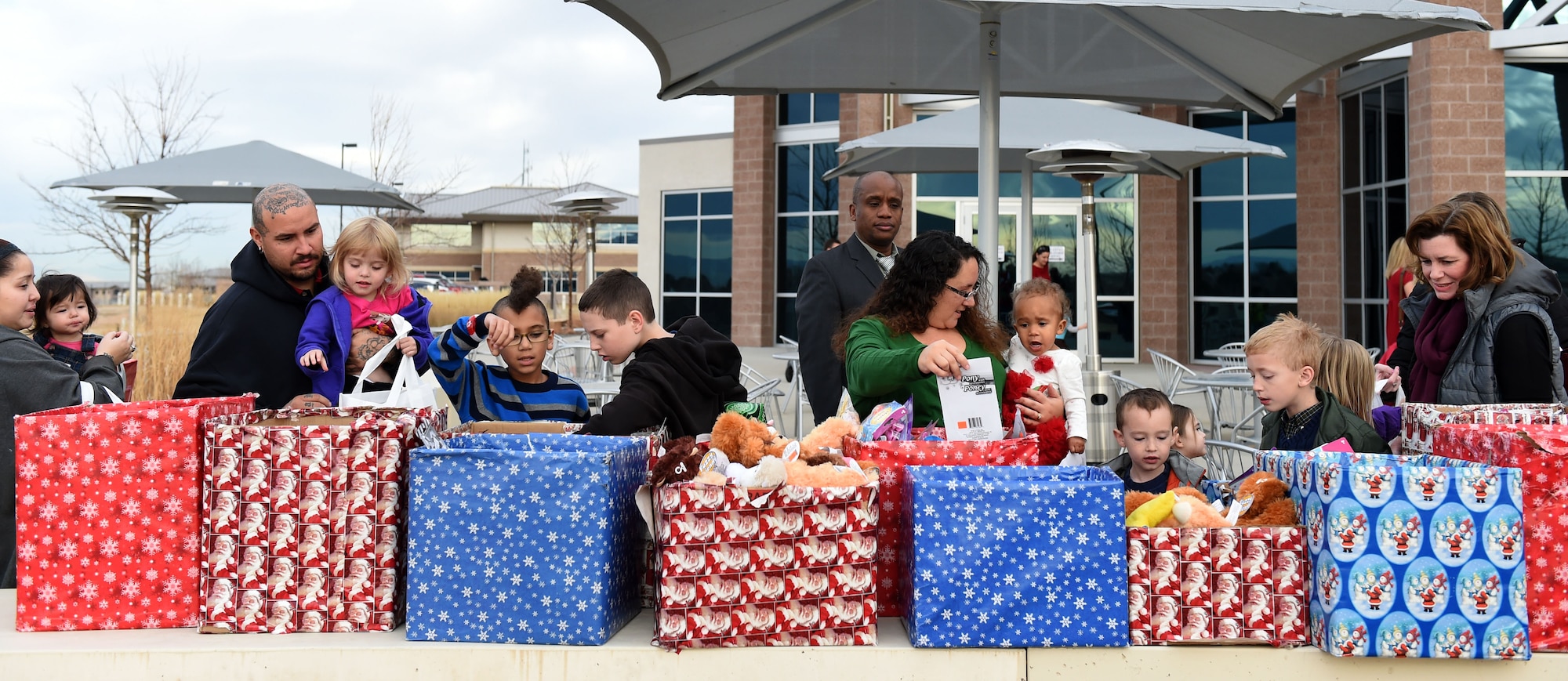 Team Buckley families pick out gifts at the annual Breakfast with Santa event Dec. 14, 2014, at the Leadership Development Center on base. At the event, Team Buckley had the opportunity to meet Mr. and Mrs. Claus, grab a pancake breakfast and pick out their favorites from a variety of gifts to raise holiday spirit. (U.S. Air Force photo by Airman 1st Class Emily E. Amyotte/Released)