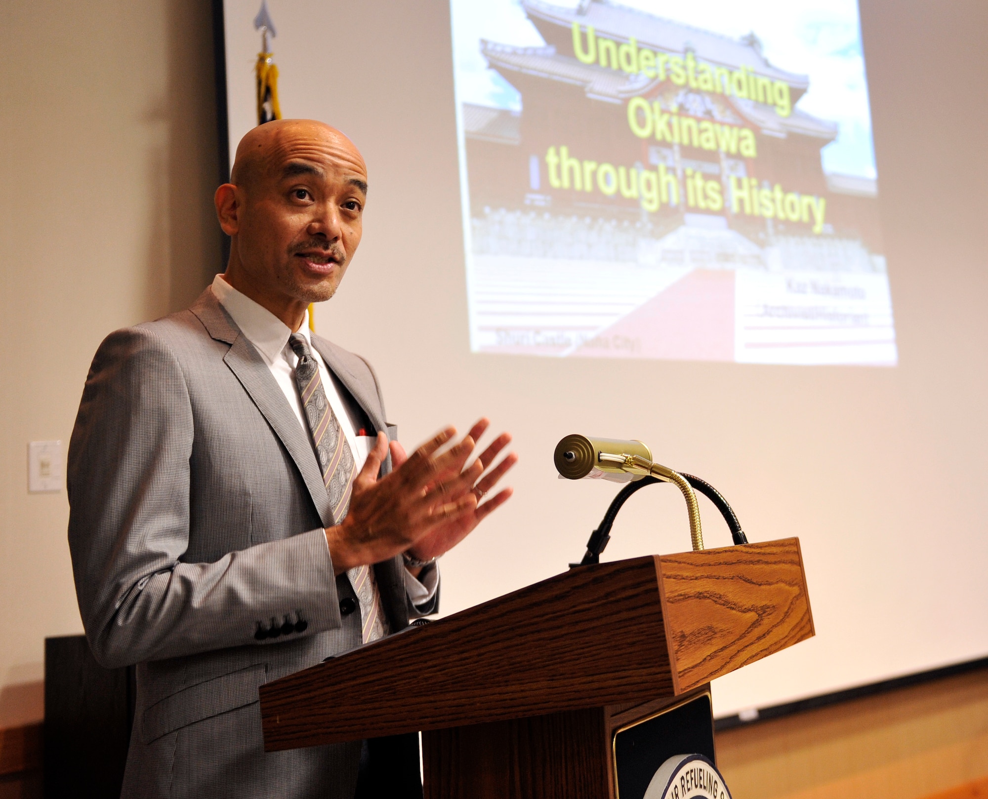 Kazuhiko Nakamoto, Okinawa Prefectural Archives archivist, speaks to Kadena members about Okinawa's history during the Ministry of Foreign Affairs' 8th Annual Cultural Seminar on Kadena Air Base, Japan, Dec. 12, 2014. The cultural brief increased Airmen's awareness of how Okinawa's past relates to local attitudes toward the U.S. military today. Members also had an opportunity to see and experience a Karate demonstration led by Masahiro Nakamoto, President of Okinawa Traditional Kobudo Preservation Society, and his assistants. (U.S. Air Force photo by Naoto Anazawa/Released)