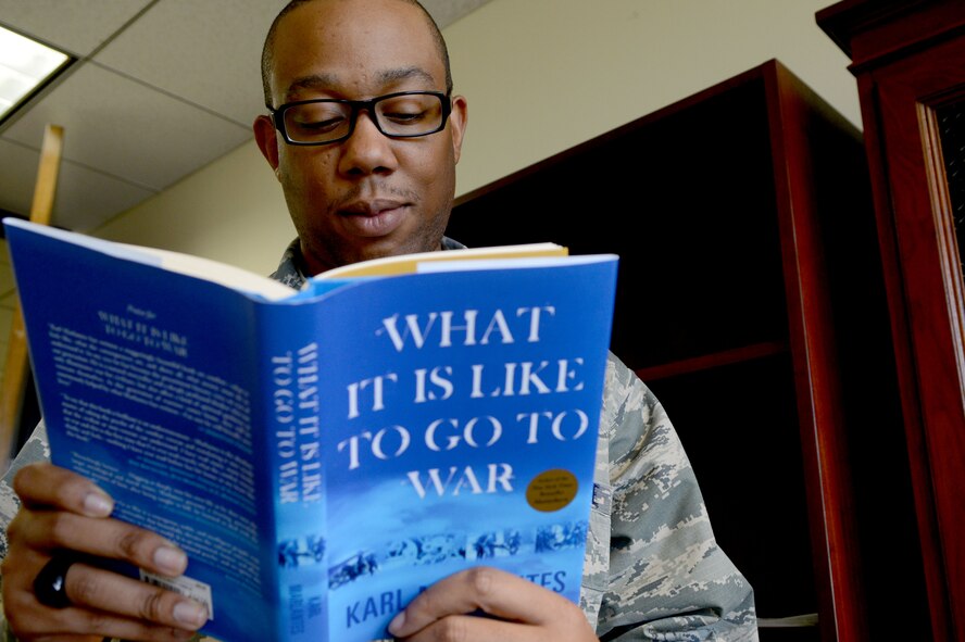 U.S. Air Force Jamyal Lett, 20th Fighter Wing Chapel program management NCO in charge reads “What is it like to go to war?” to gather key points of resiliency at Shaw Air Force Base, S.C., Dec. 15, 2014. Building spiritual care for Airmen and Soldiers starts before they enter the deployed environment and it is integral in making sure that they can perform at a high level under intense stressors.  The Shaw Chaplain Corps offers free literature to support Airmen in their quest to become spiritually resilient. (U.S. Air Force photo by Senior Airman Ashley L. Gardner/Released)