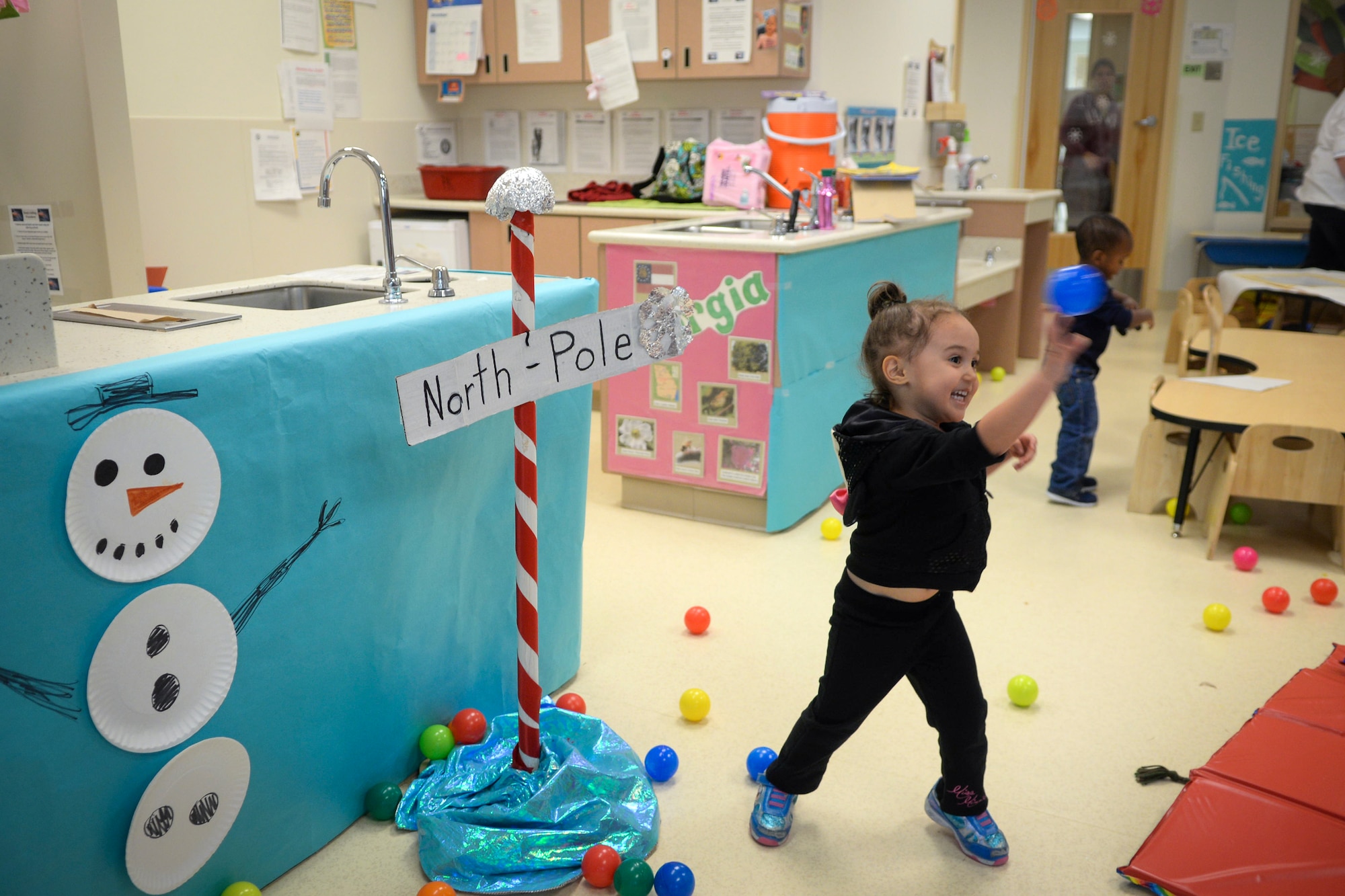 Gia Soriano, daughter of U.S. Air Force Senior Airman Erin Soriano, 23d Maintenance Operations Squadron, plays during Winter Wonderland Dec. 12, 2014, at Moody Air Force Base, Ga. The event included a ball pit, finger painting, frozen treats and simulated ice fishing. (U.S. Air Force photo by Senior Airman Sandra Marrero/Released)

