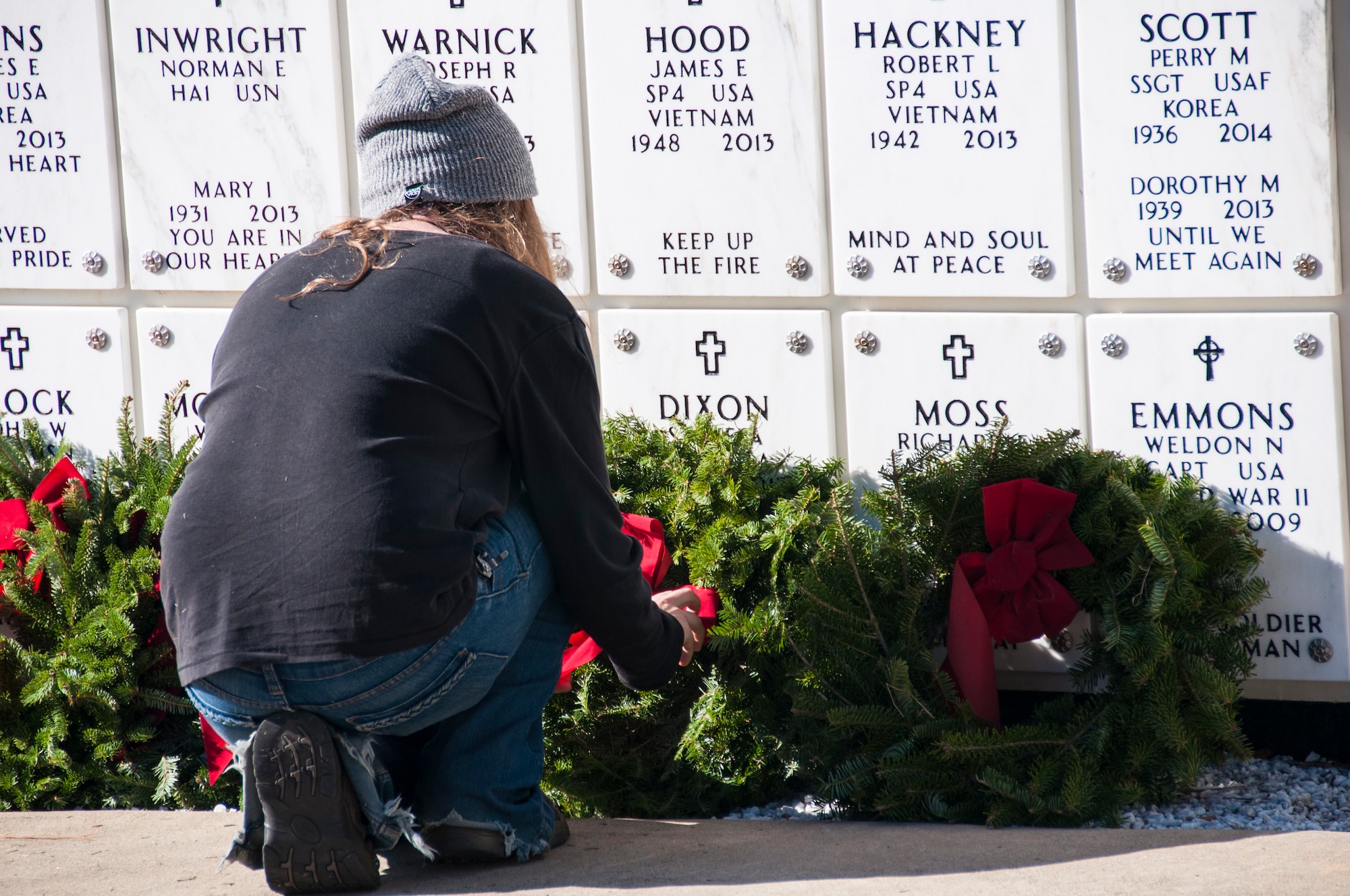A volunteer prepares to lay a wreath for the Wreaths Across America Ceremony at Georgia National Cemetery in Canton, Ga. Dec. 13, 2014. Thousands showed up to GNC to honor America’s heroes. (U.S. Air Force photo/Senior Airman Daniel Phelps)