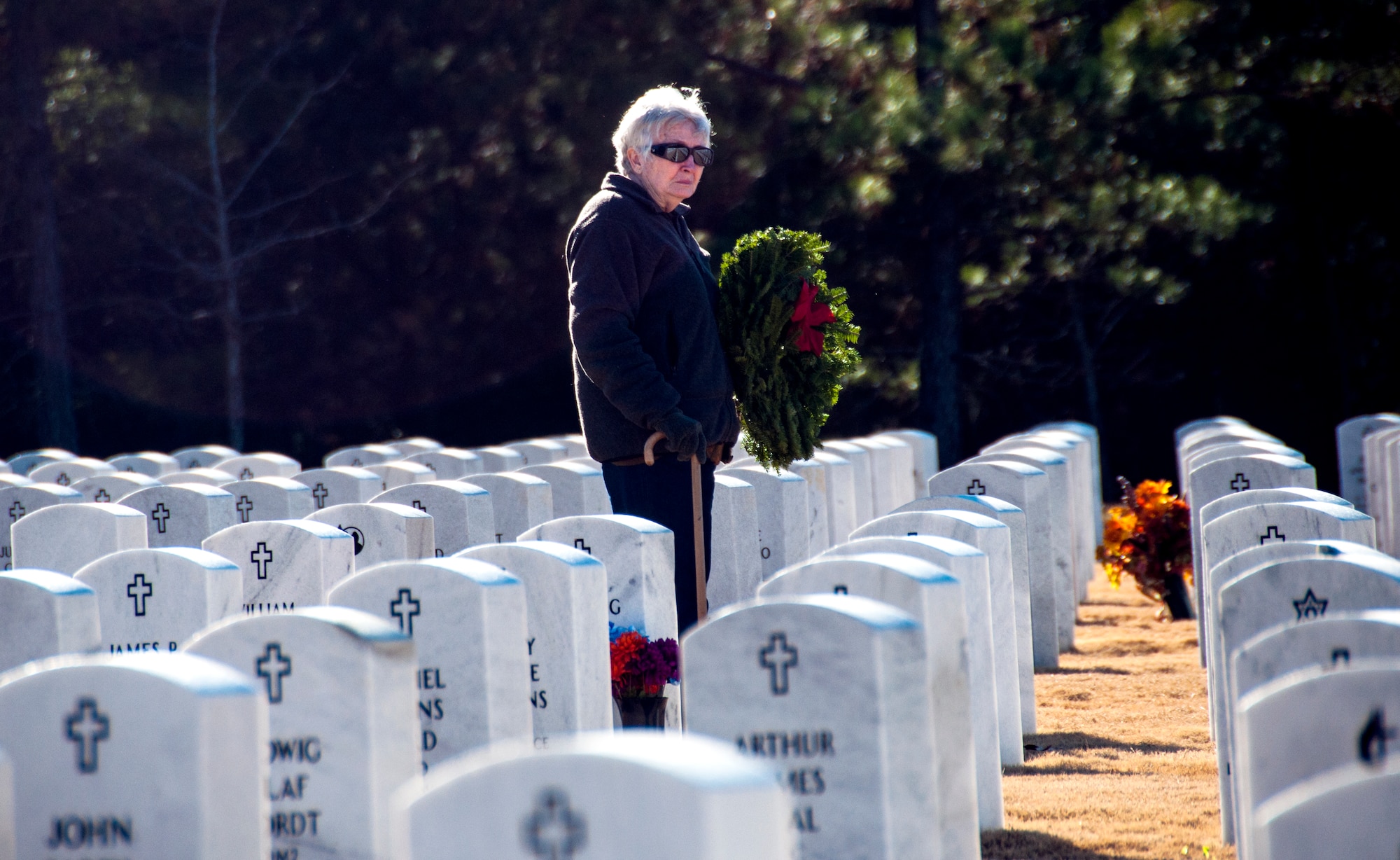 A volunteer prepares to lay a wreath for the Wreaths Across America Ceremony at Georgia National Cemetery in Canton, Ga. Dec. 13, 2014. Thousands showed up to GNC to honor America’s heroes. (U.S. Air Force photo/Senior Airman Daniel Phelps)