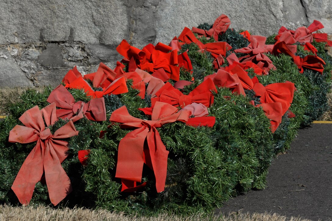 Wreaths lay waiting to be placed on gravesites of fallen U.S. Service members during the Wreaths Across America Day wreath-laying ceremony at the Hampton National Cemetery in Hampton, Va., Dec. 13, 2014. Program participants laid wreaths at more than 900 memorial cemeteries nationwide and overseas. (U.S. Air Force photo by Staff Sgt. Teresa J. Cleveland/Released)