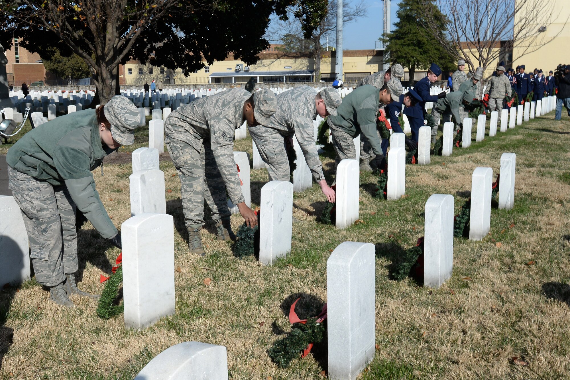 Service members from Joint Base Langley-Eustis and the local community participate in a wreath-laying ceremony as part of Wreaths Across America Day at the Hampton National Cemetery in Hampton, Va., Dec. 13, 2014. Volunteers worked together to lay wreaths on 7,000 gravesites at the cemetery. (U.S. Air Force photo by Staff Sgt. Teresa J. Cleveland/Released)