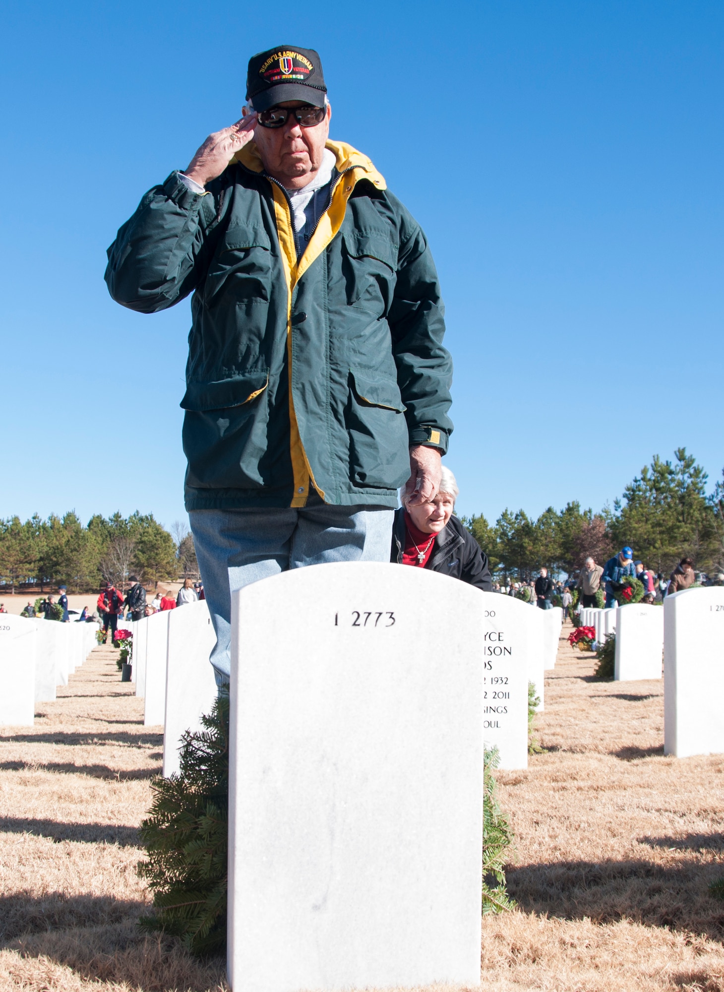 A volunteer salutes a gravestone after laying his wreath at the Wreaths Across America ceremony in Canton, Ga. at Georgia National Cemetery Dec. 13, 2014. Thousands showed up to GNC to honor America’s heroes. (U.S. Air Force photo/Senior Airman Daniel Phelps)