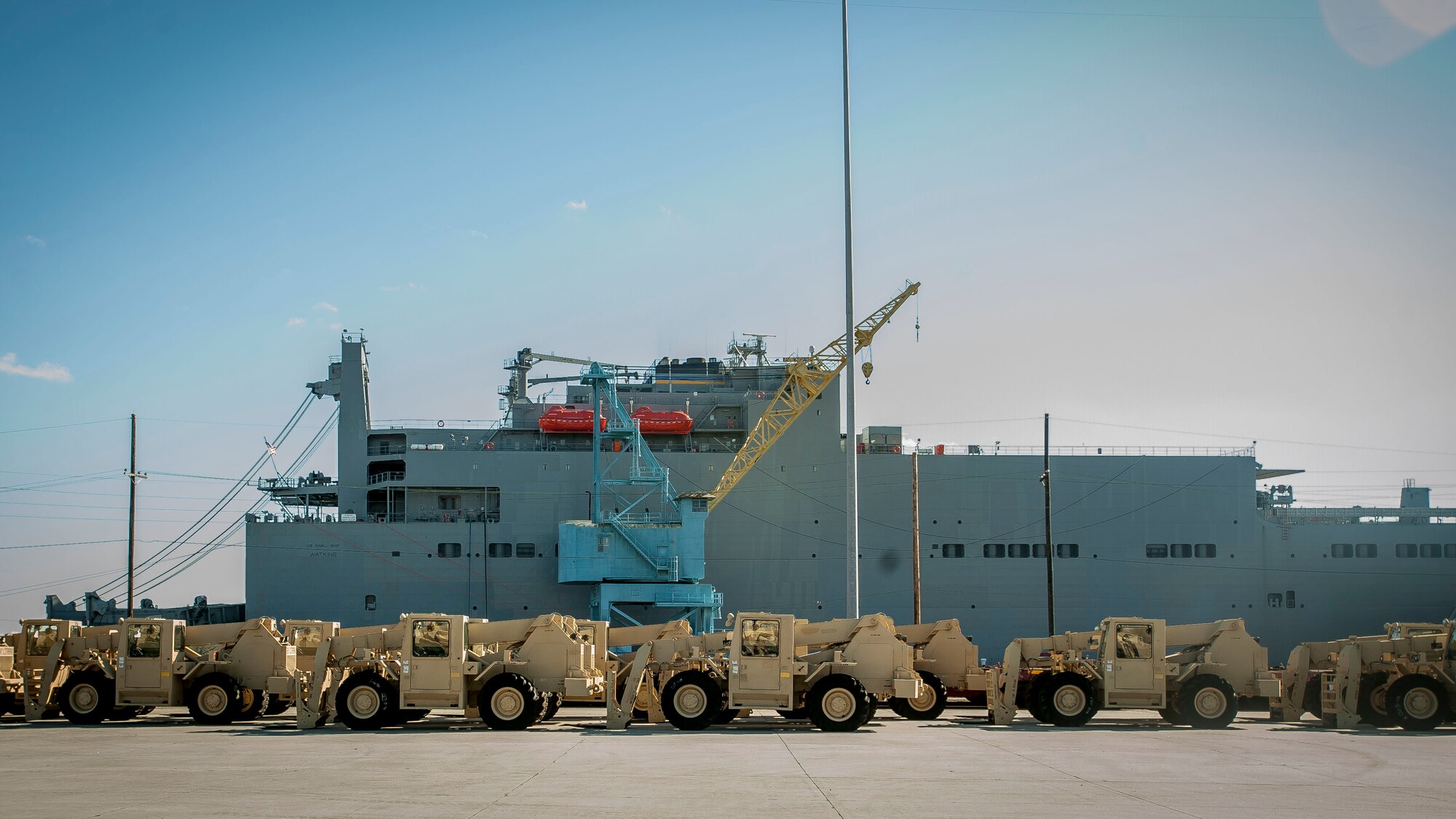 Army vehicles wait to be loaded onto the USNS Watkins (T-AKR 315), Dec. 10, 2014, at Joint Base Charleston, S.C. Once loaded with more than 1,200 pieces of military equipment, the 950-foot long ship will embark to a prepositioned location overseas. (U.S. Air Force photo / Senior Airman Tom Brading)