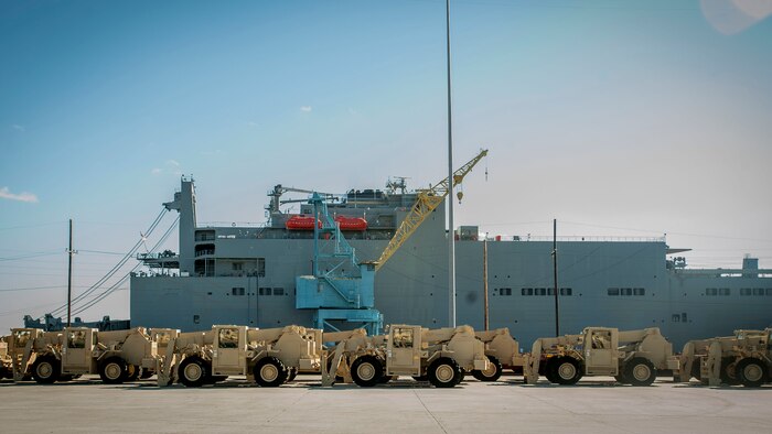 Army vehicles wait to be loaded onto the USNS Watkins (T-AKR 315), Dec. 10, 2014, at Joint Base Charleston, S.C. Once loaded with more than 1,200 pieces of military equipment, the 950-foot long ship will embark to a prepositioned location overseas. (U.S. Air Force photo / Senior Airman Tom Brading)