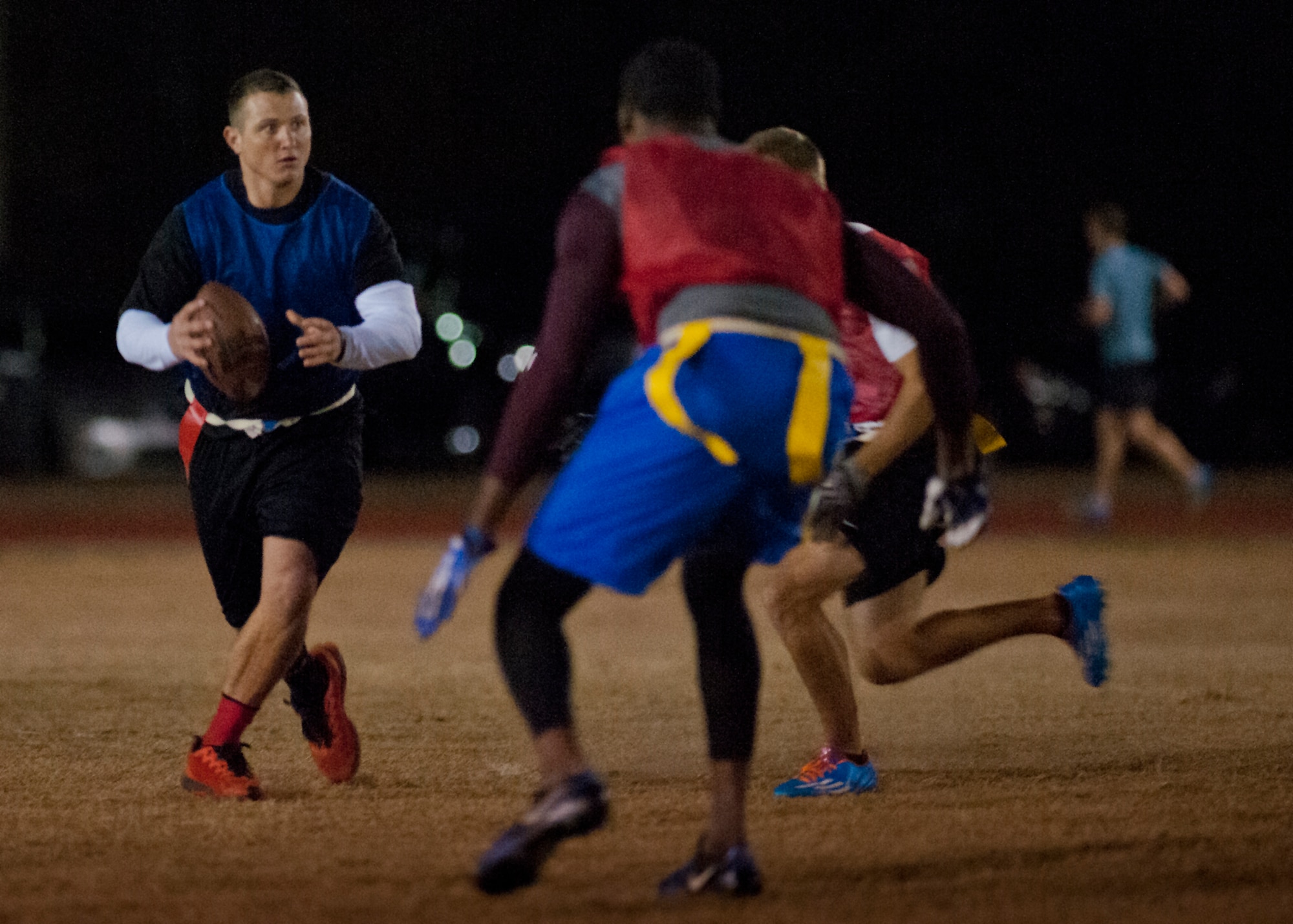 Nicholas Ott, 96th Security Forces Squadron, looks downfield for a receiver during a play at the base intramural flag-football championship game Dec. 11 at Eglin Air Force Base, Fla.  The EB team won in an overtime battle 25-24 and repeated as base champions.  (U.S. Air Force photo/Samuel King Jr.)