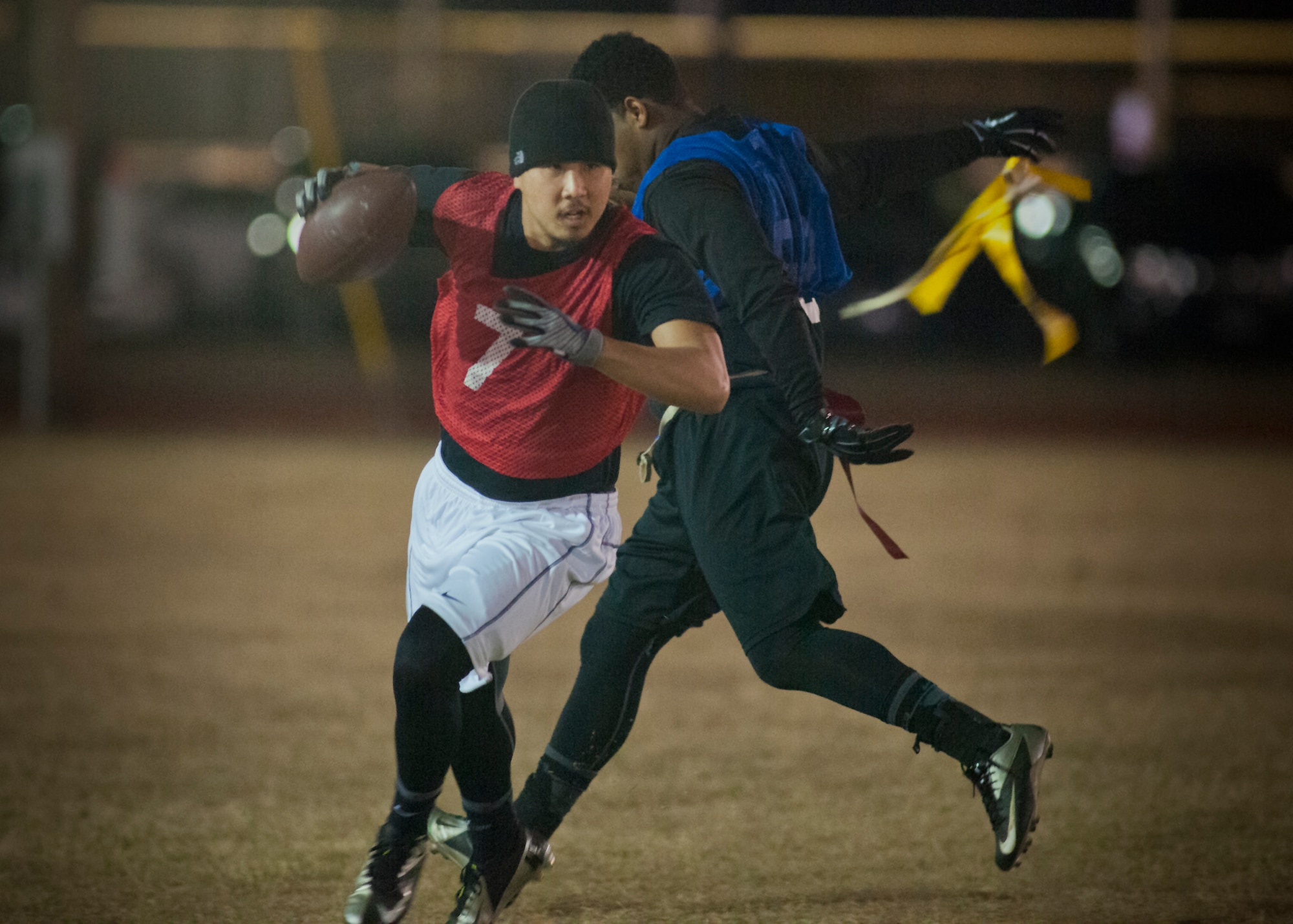 A 96th Security Forces Squadron defender pulls the flag of an Armament Directorate player during the base intramural flag-football championship game Dec. 11 at Eglin Air Force Base, Fla.  The EB team won in an overtime battle 25-24 and repeated as base champions.  (U.S. Air Force photo/Samuel King Jr.)