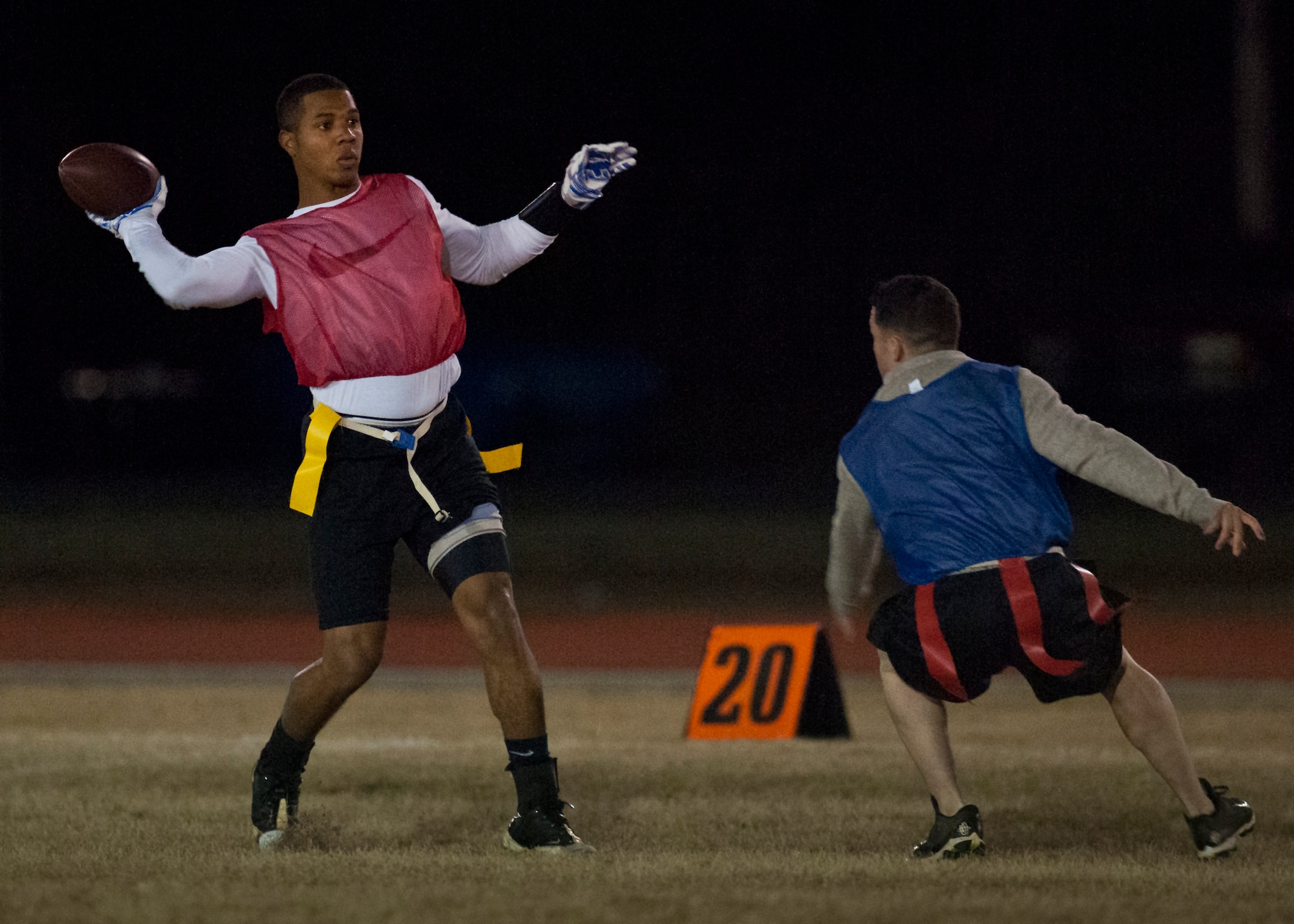 Savier Stephens, with the Armament Directorate team, passes the ball downfield as a 96th Security Forces Squadron defender moves in during the base intramural flag-football championship game Dec. 11 at Eglin Air Force Base, Fla.  The EB team won in an overtime battle 25-24 and repeated as base champions.  (U.S. Air Force photo/Samuel King Jr.)